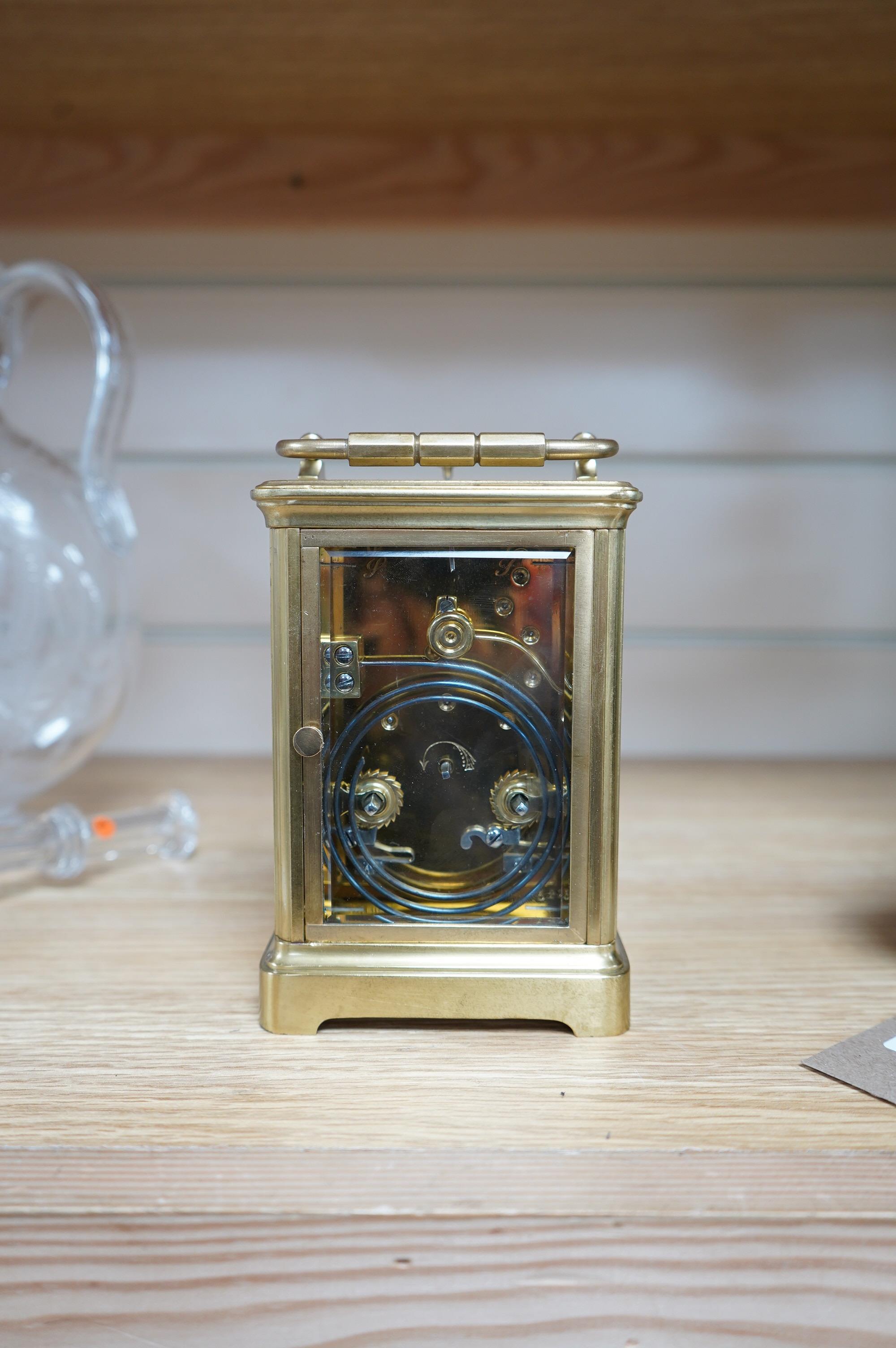 A brass cased repeating carriage clock, retailed by Edwards & Sons Ltd., no key, 15cm. Condition - fair to good, not tested